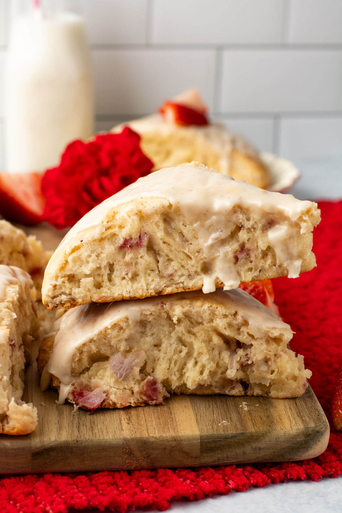 2 strawberry scones in a pile on a wooden board.