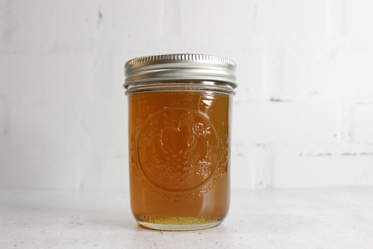 mason jar with silver metal lid containing homemade cough syrup 