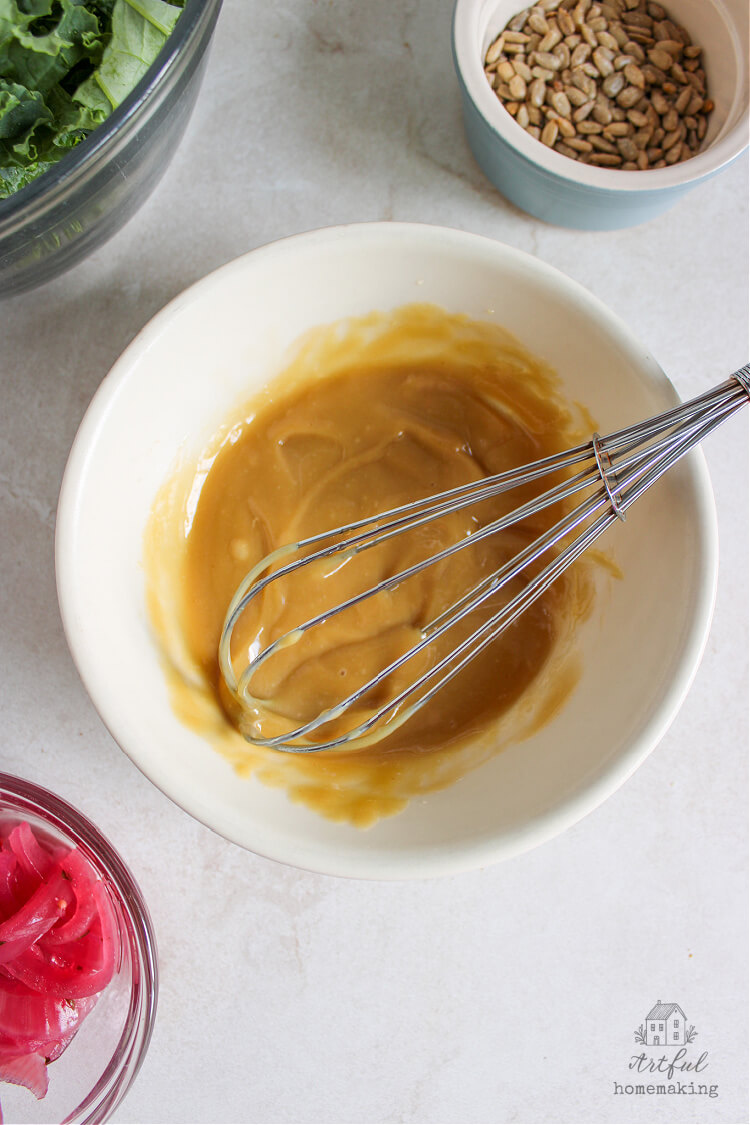 homemade tahini Dijon salad dressing being whisked in a bowl