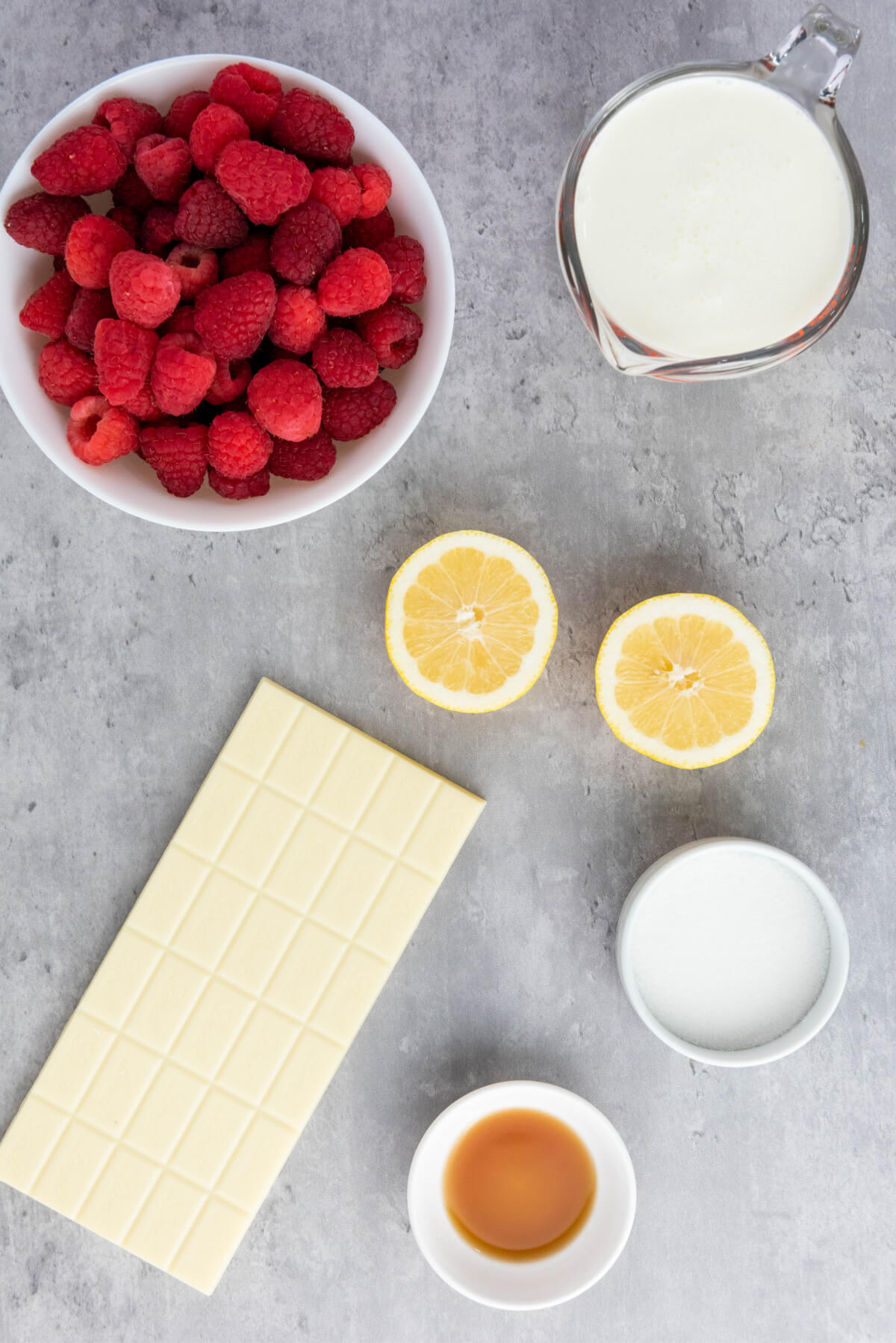 top down view of ingredients in small white bowls on a gray marble countertop