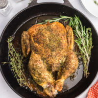whole roasted chicken in a cast iron skillet
