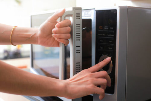 woman using microwave oven