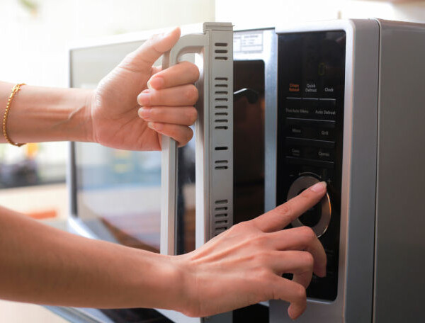 woman using microwave oven